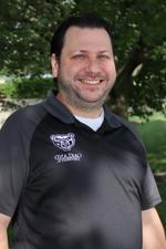 A headshot of Chris Stepanian Bennett outdoors